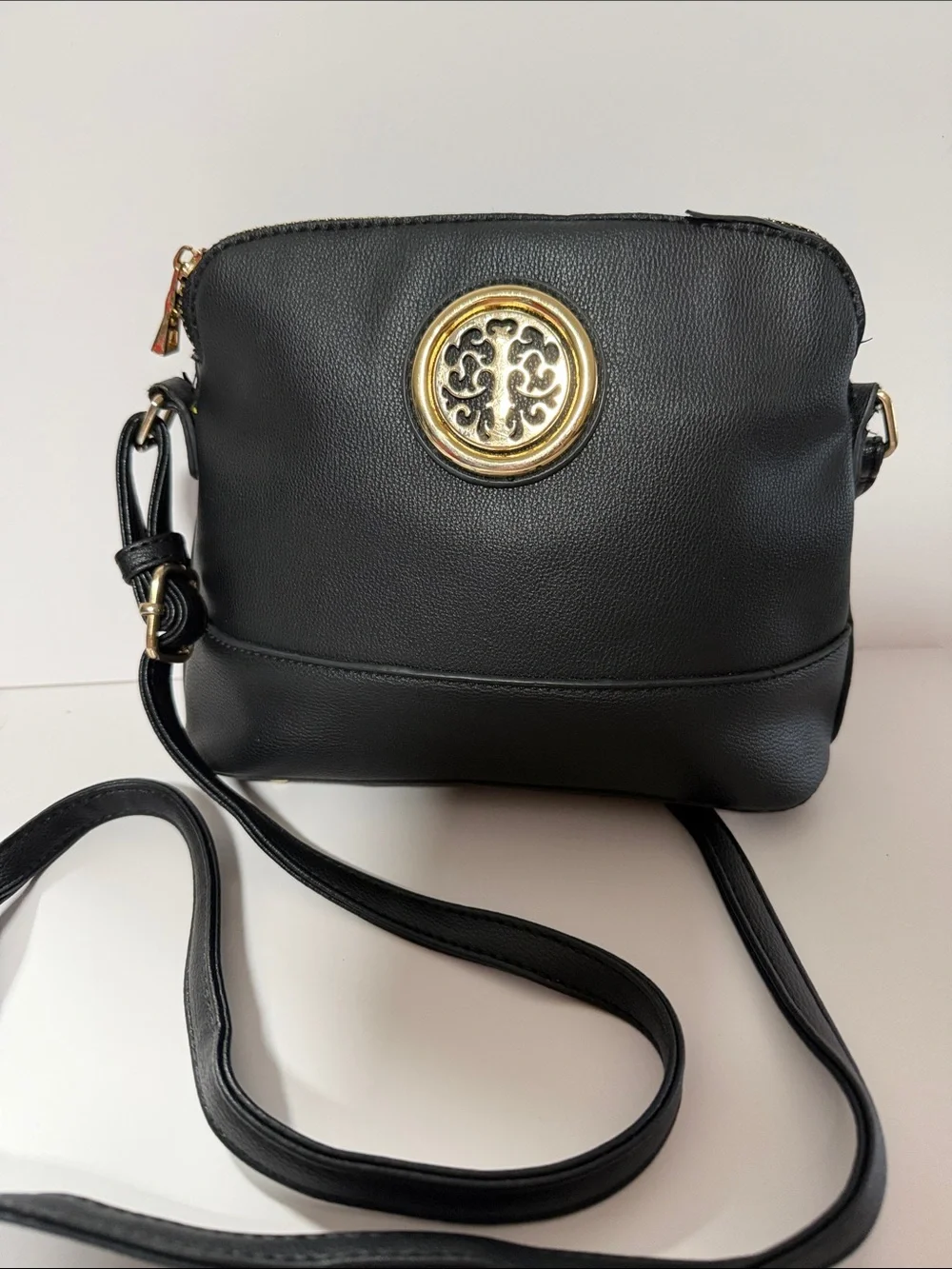 Black Crossbody Bag with Gold Medallion